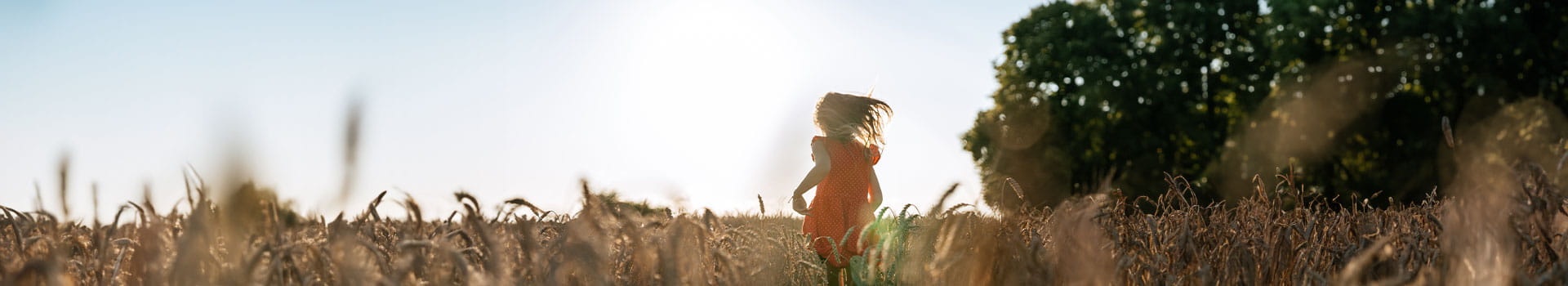 girl running on fields in sunset